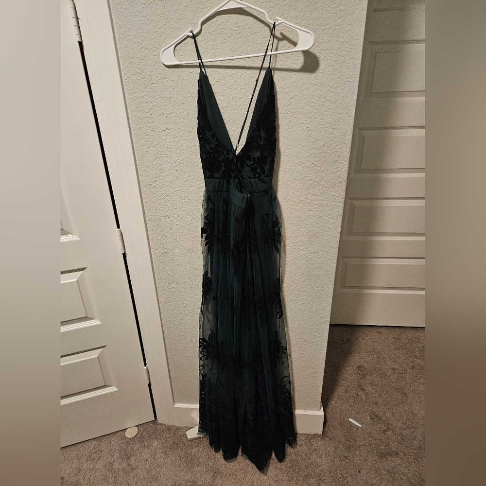 A long floral dark green dress with slit